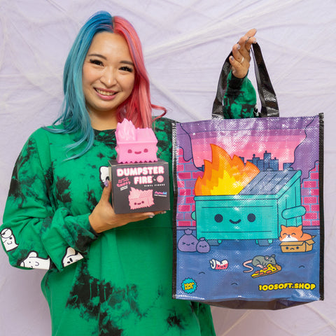 Model holding the Pink Dumpster Fire Ghost and reusable bag