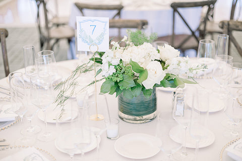 Greens and florals with crest table number