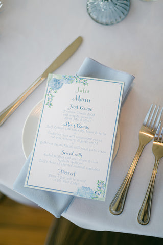 close up wedding menu with hydrangea