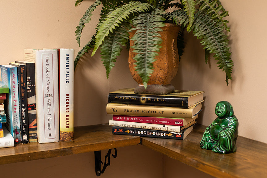 plant and Buddah and books