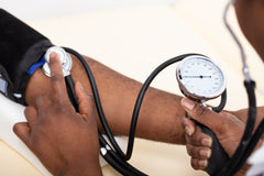 doctor checking patient's blood pressure