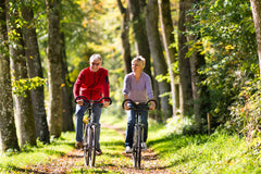 man and woman riding bikes outside