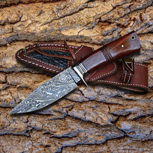 https://cdn.shopify.com/s/files/1/1133/7544/products/legendary-wilderness-walnut-damascus-knife-yellowstone-spirit-southwestern-collection-hunting-survival-knives-objects-of-beauty-southwest-618044_1600x.jpg?v=1684028238