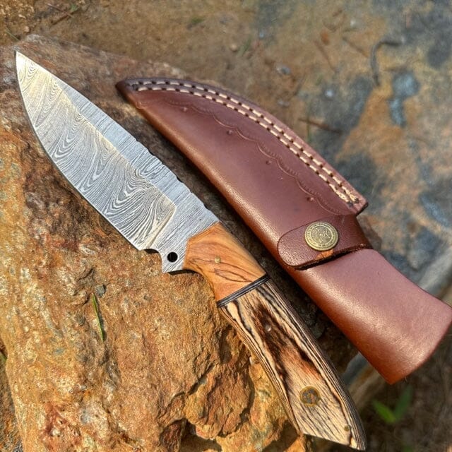 https://cdn.shopify.com/s/files/1/1133/7544/products/olive-rosewood-damascus-hunting-skinner-knife-yellowstone-spirit-southwestern-collection-damascus-knife-objects-of-beauty-southwest-200260_1600x.jpg?v=1685676041