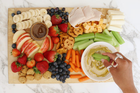 snack board filled with fruits and vegetables