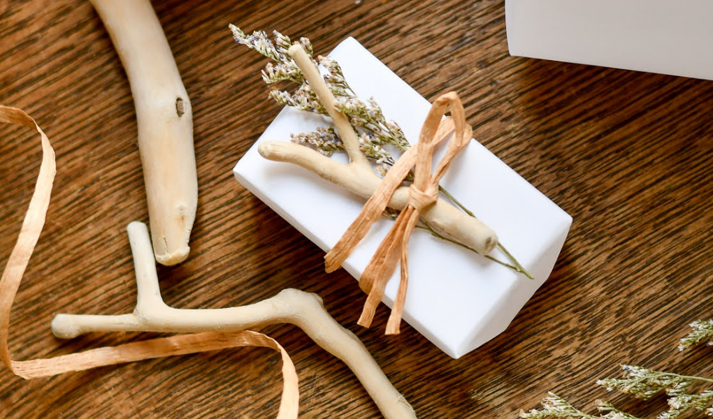 beachy gift wrap with drift wood, dried flowers, and twine for a coastal christmas