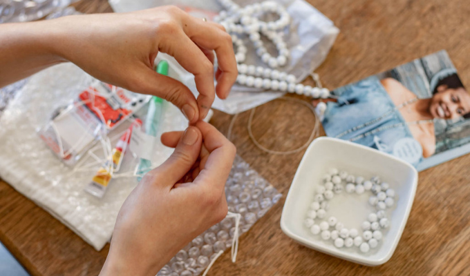 working on a sailormade whatknot beaded necklace and bracelet kit in howlite