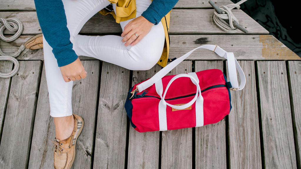 paul landry co sailing duffle bag on a boardwalk with boat shoes