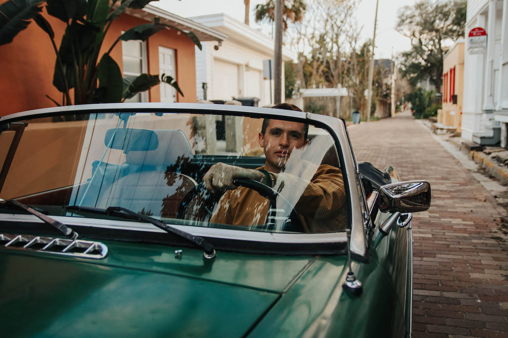 paul landry in vintage car wearing brooks brothers and sailormade nautical bracelets in Florida