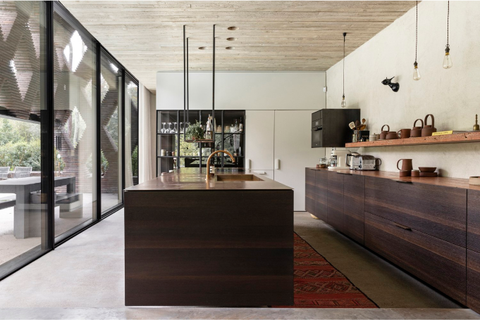 The modern, glass-walled kitchen in the residence