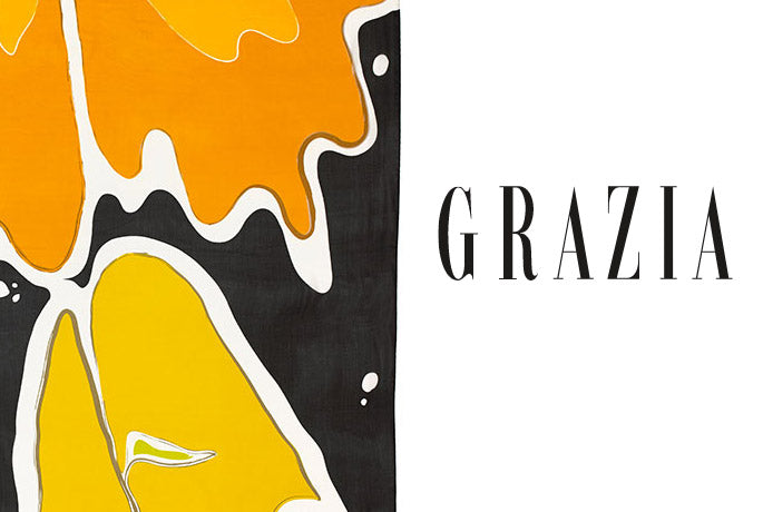 The Grazia text logo in white on a white backround with a detail of Darshana Silpi Rouget's silk shawl, Leaflet - a bold renderin gof atumn leaves falling in oranges and black