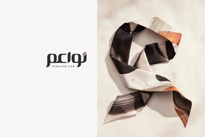 NAWA3EM logo on the left, Alba Amicorum silk twilly scarf in warm tones, neatly folded on the right