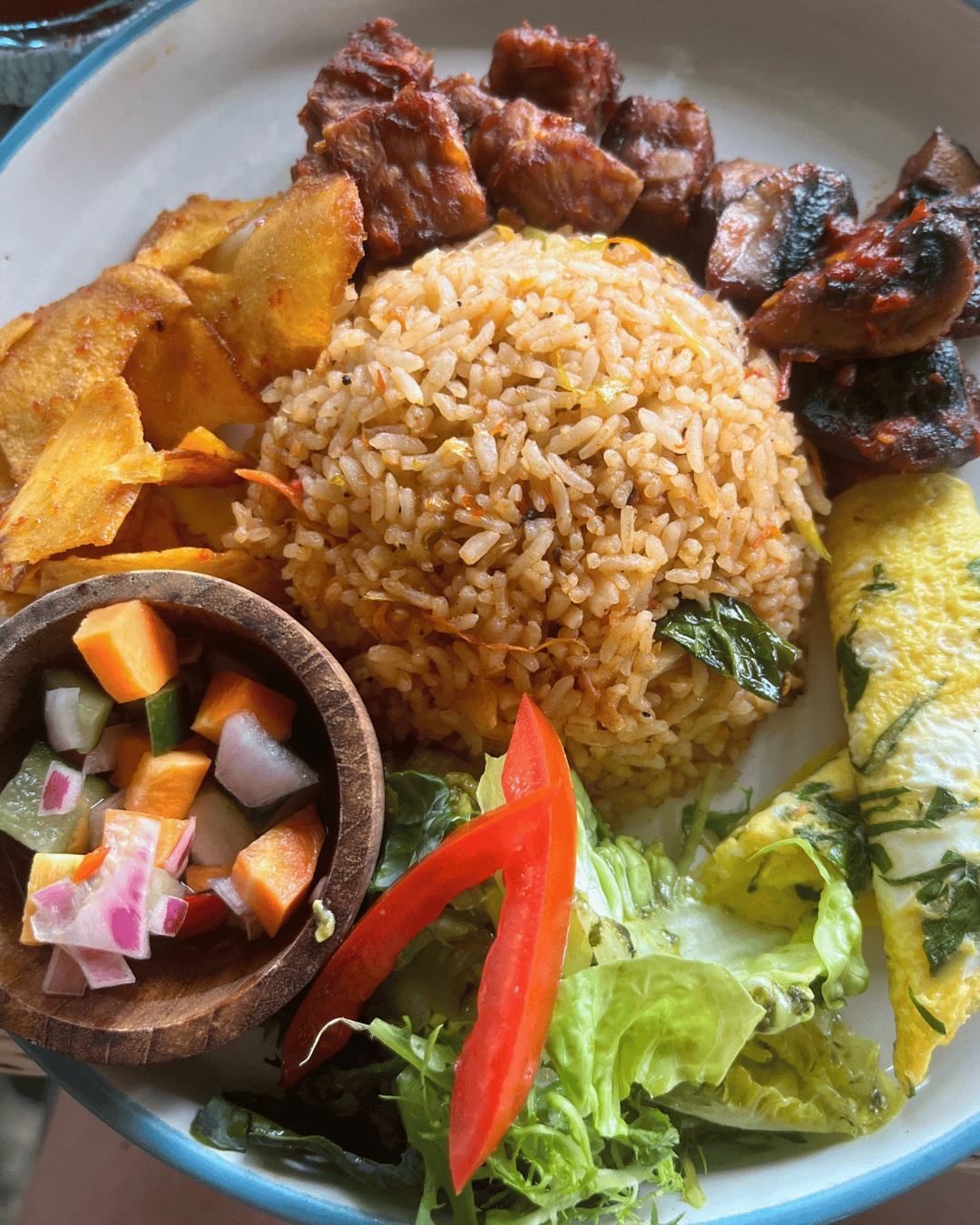 plate of food containing rice, lettuce, fruit, and meat