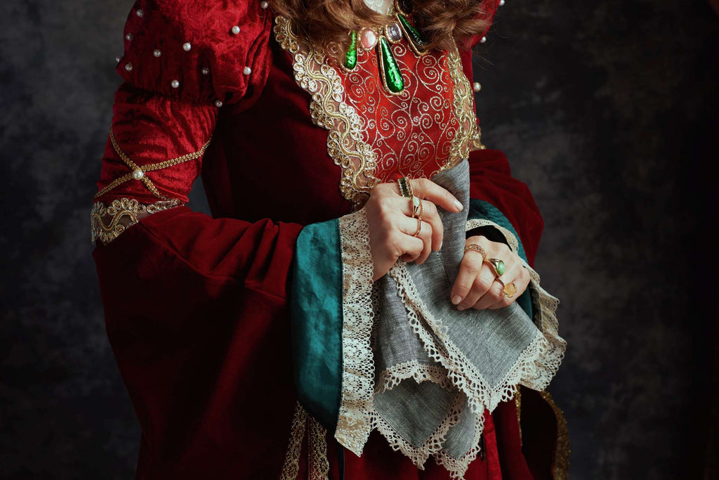 Closeup on medieval queen in red dress with handkerchief