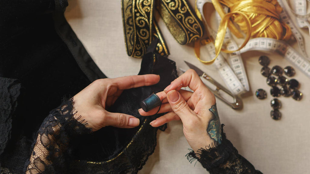 Woman sews a Renainssance  dress