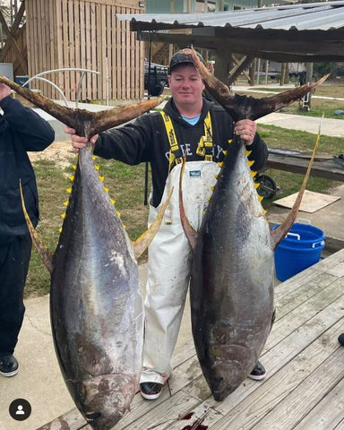 Man holding 2 Tuna Fish