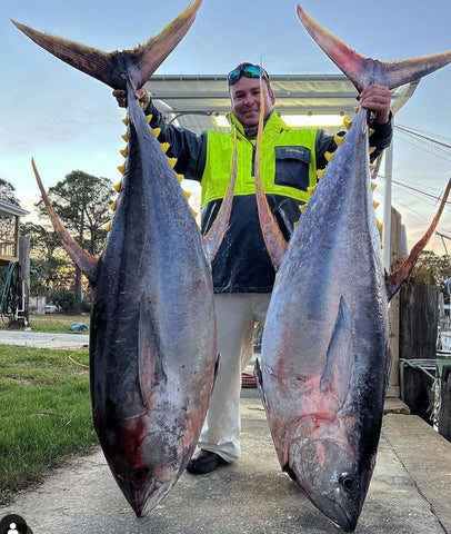 man with two large fish