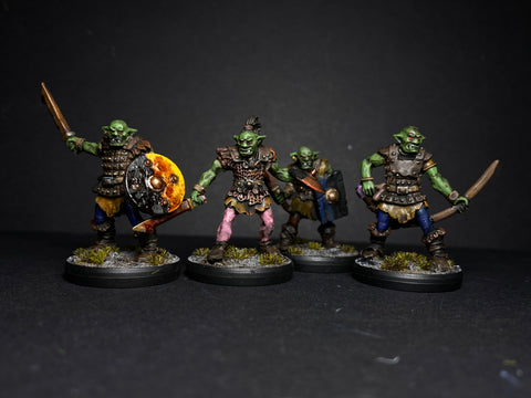 a set of 4 hobgoblin miniatures , painted with metal armour and green skin for tabletop gaming