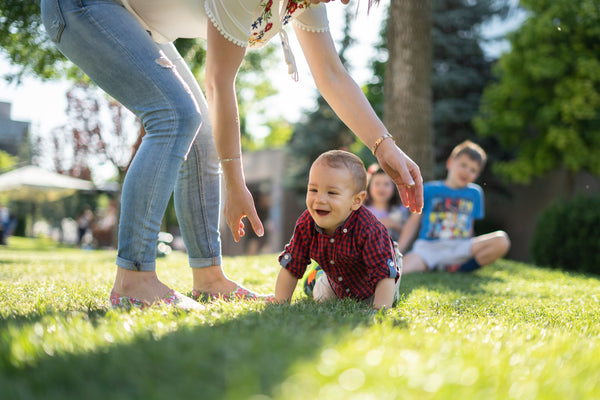 Mom outside playing with her children