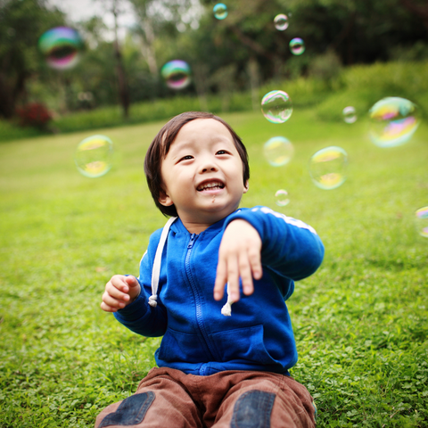 child playing with bubble