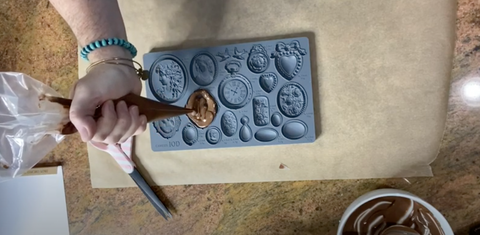 Piping chocoloate into IOD Cameo Mold