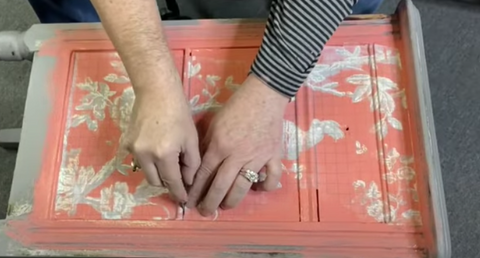 Cut paint inlay paper between drawers with razor blade or exacto knife
