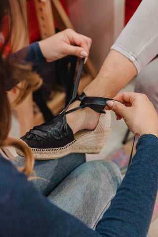 Lacing up traditional espadrilles in Barcelona