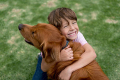 Child hugging dog