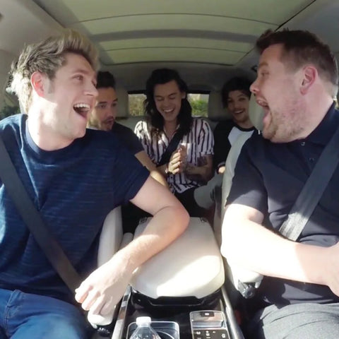 carpool karaoke men laughing in a car