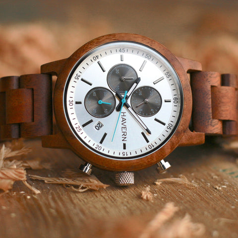 the orion koa wooden watch laying down on its side