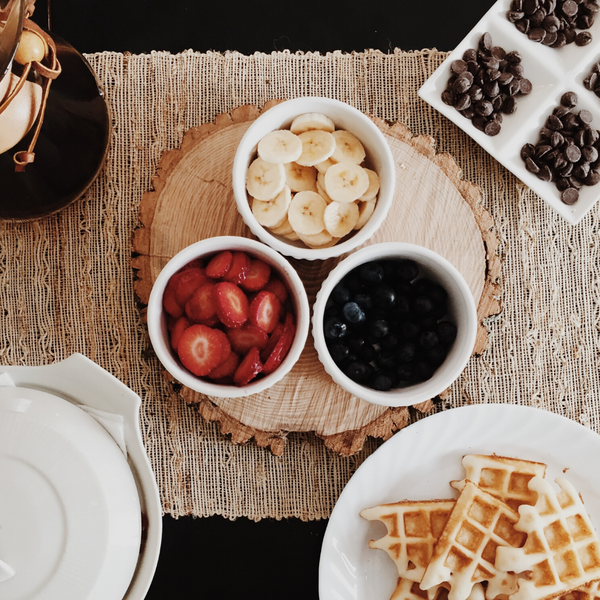 Waffles with Waffle Toppings Laid Out on Kitchen Table