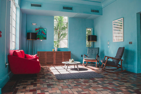 Colorful room with teal colored walls and tile floors