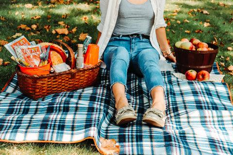 A woman with NEATsheets in her picnic basket.