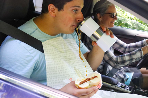 Man drinking coffee in the car wearing a Grey Dot NEATsheet.