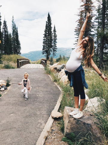 pregnant mom breathing deeply in the outdoors