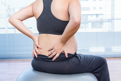 woman holding back support during pregnancy