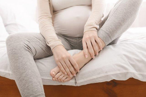 pregnant woman rubbing her feet