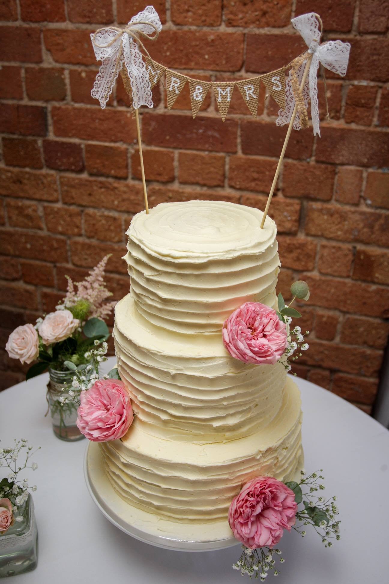Natural style wedding cake with pink Peony decoration.