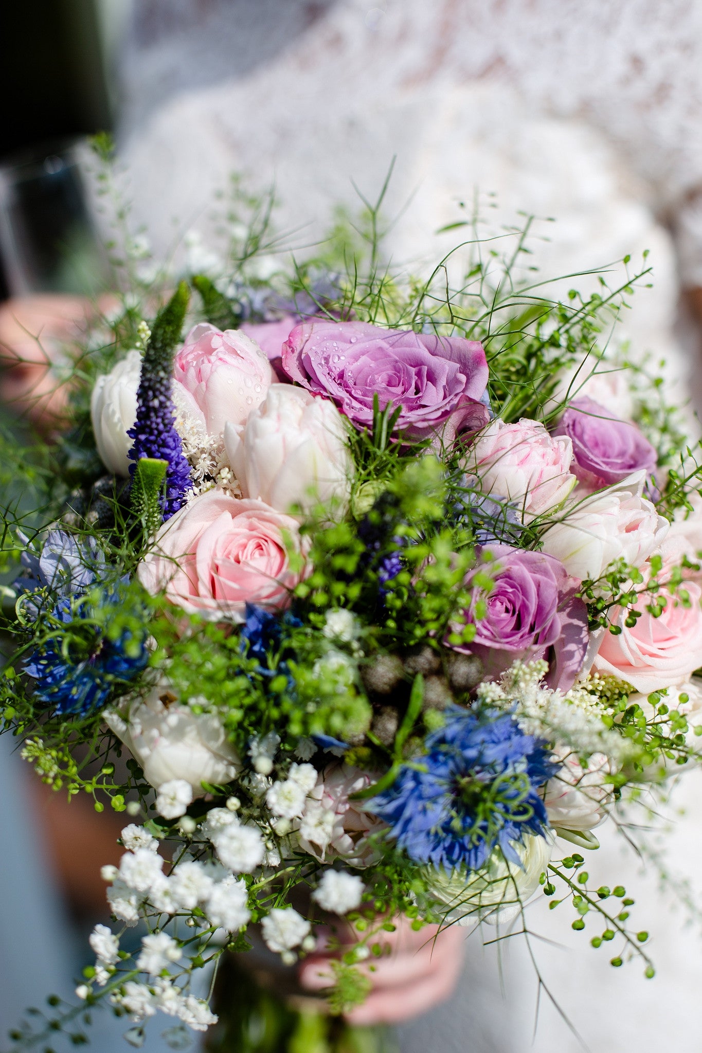 Bridal bouquet with pale pink Roses, lilac Lisianthus, blue Nigella, Veronica, Thlaspi and Gypsophila.
