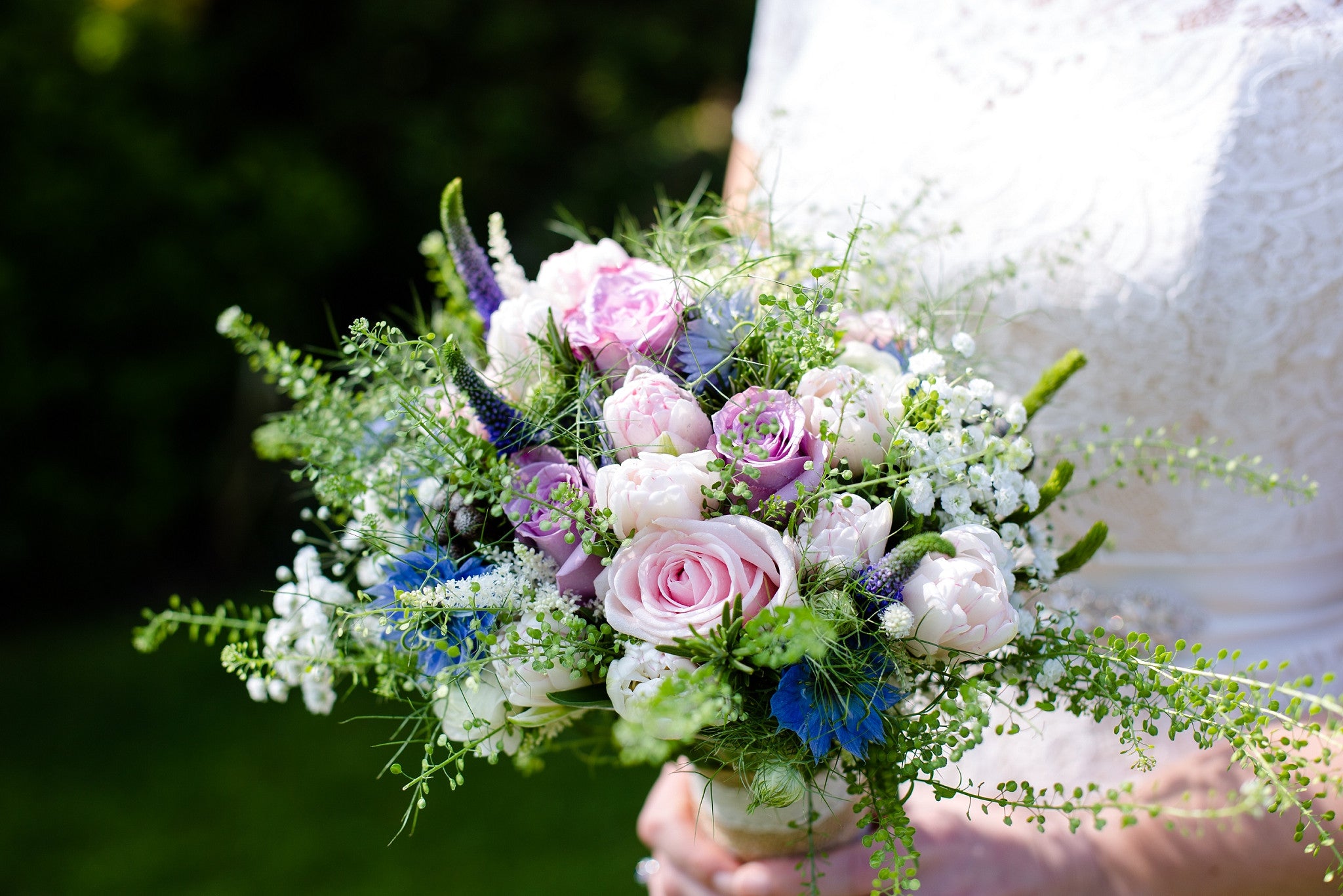 Bridal bouquet made up of pale pink Roses, lilac Lisianthus, blue Nigella, Veronica, Thlaspi and Gypsophila.