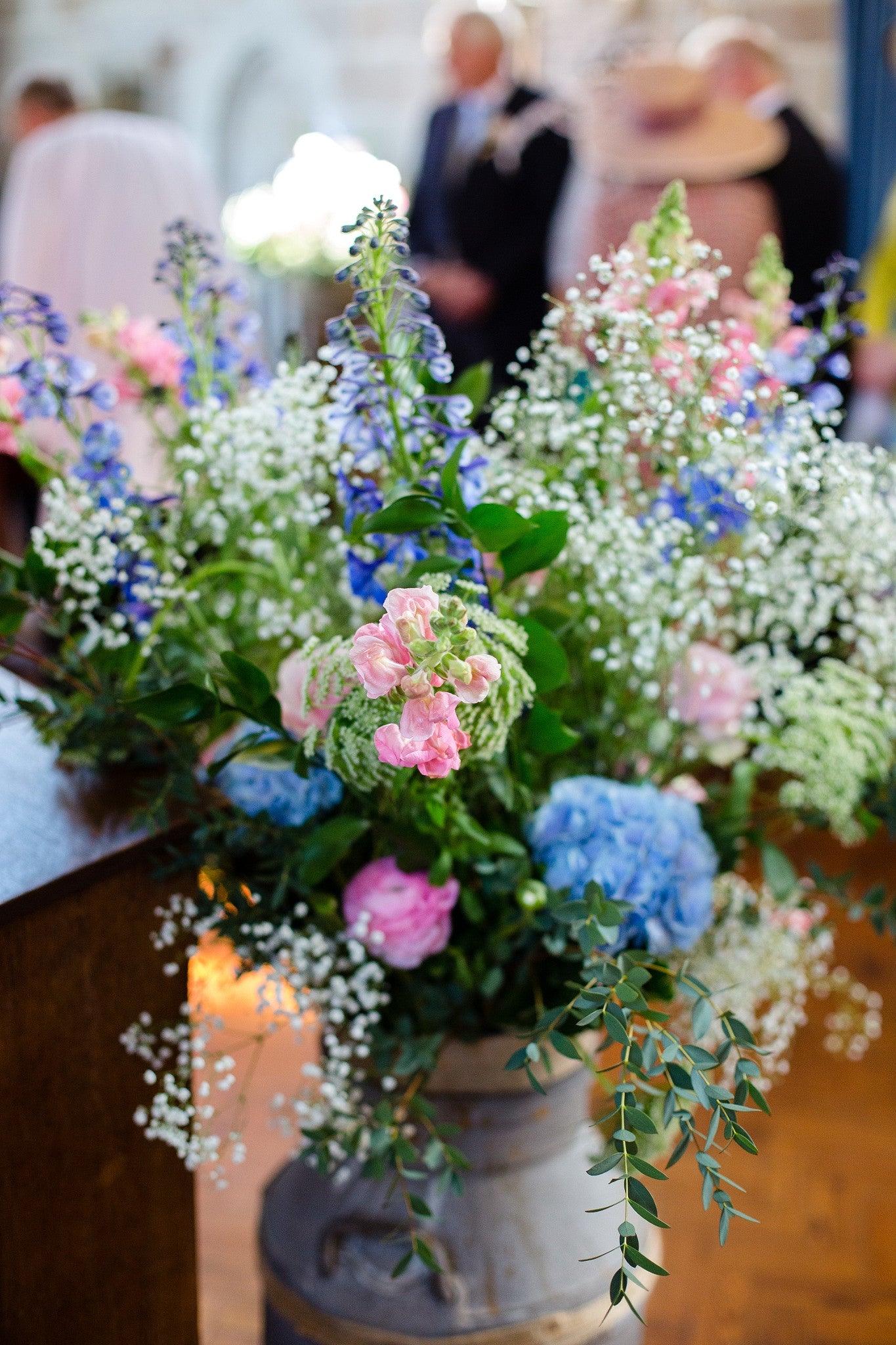 Church floral wedding decorations in shades of pink and blue.