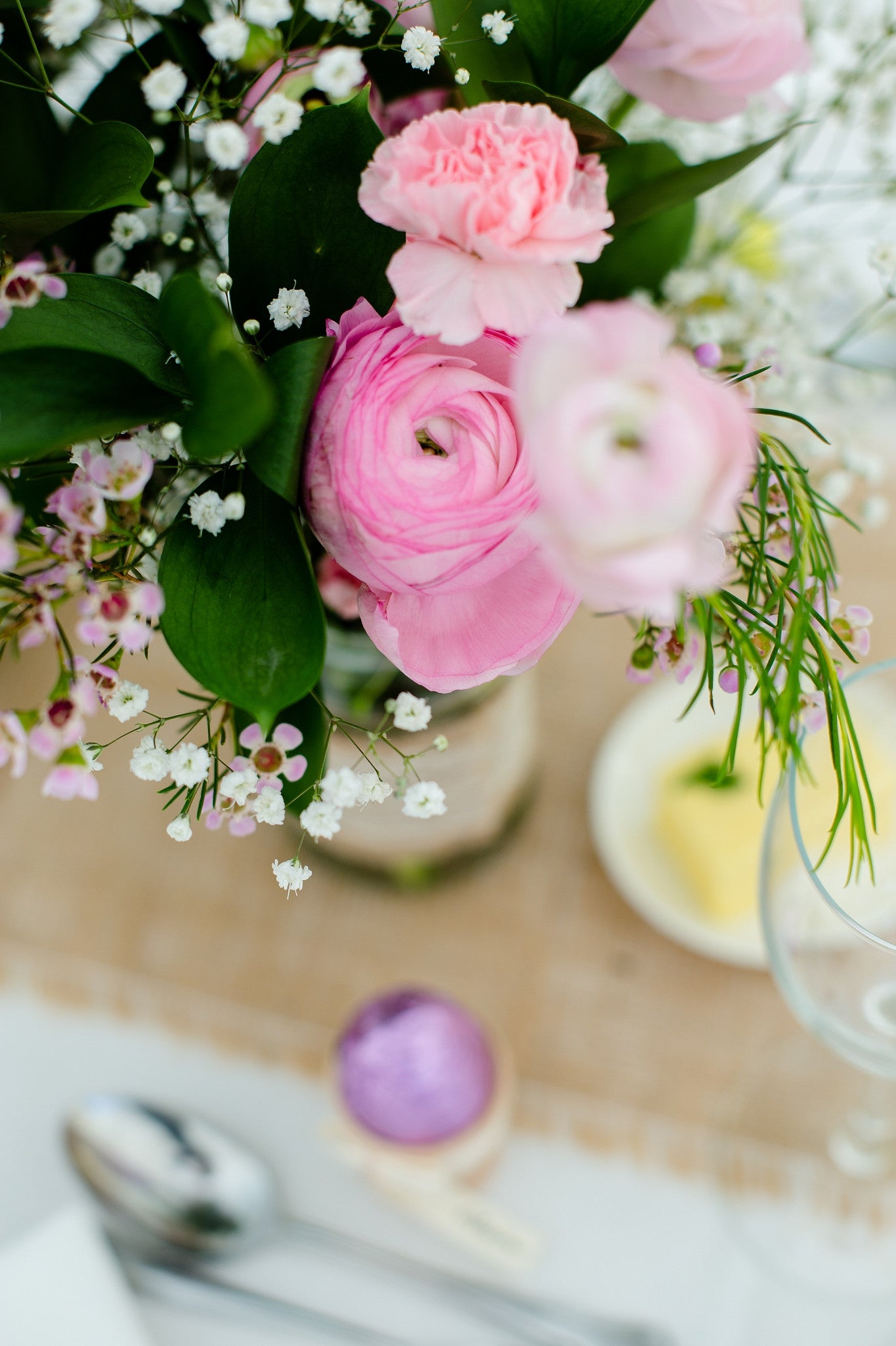 Close up of pink Ranunculus in wedding arrangement.