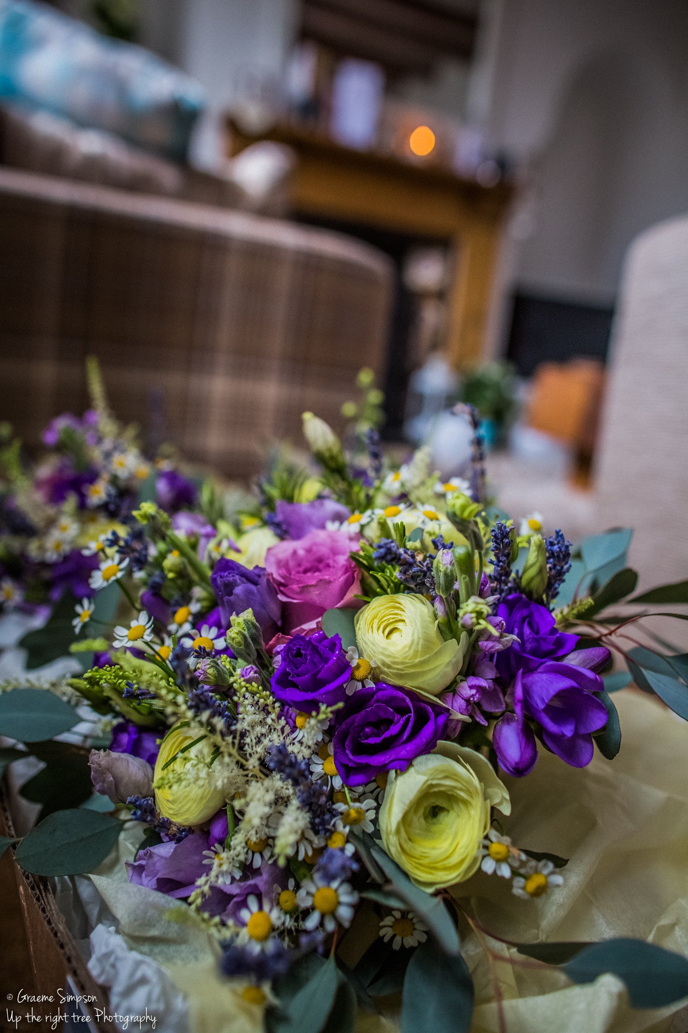 Purple Lisianthus really sets of the cream Ranunculus in this bridal bouquet.