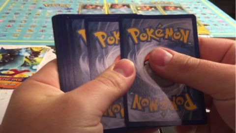 Hand Holding Pokemon Cards