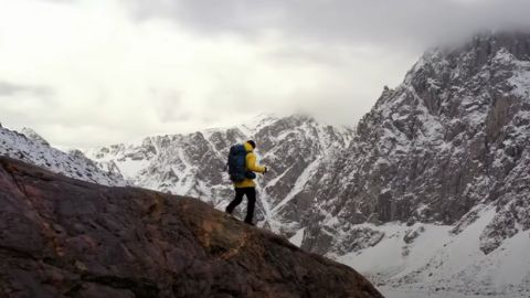 Person Walking on a top of the Mountain