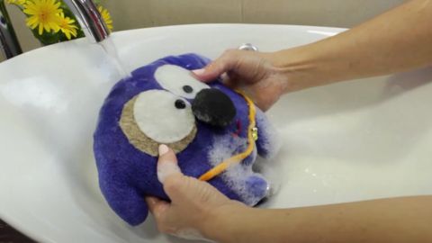 Rinsing Stuff Toy with Running Water