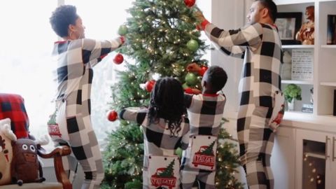 a family wearing  matching onesies pajama