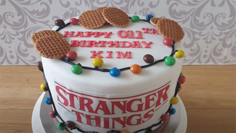 stranger things theme cake on a wooden table