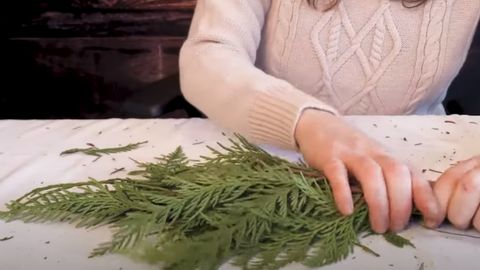 woman holding  Holiday Cedar Garland