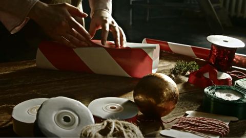 woman wrapping gift